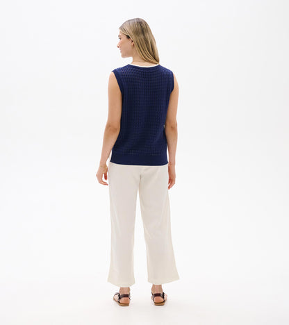 Back view of navy knit sleeveless tank top with ribbed trim and textured pattern
