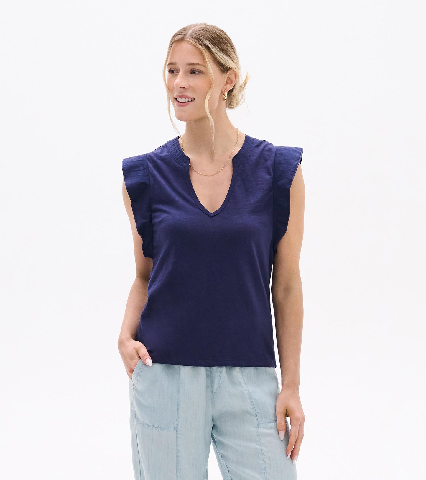 Navy sleeveless V-neck tank top with ruffled shoulders, shown on a model front view.