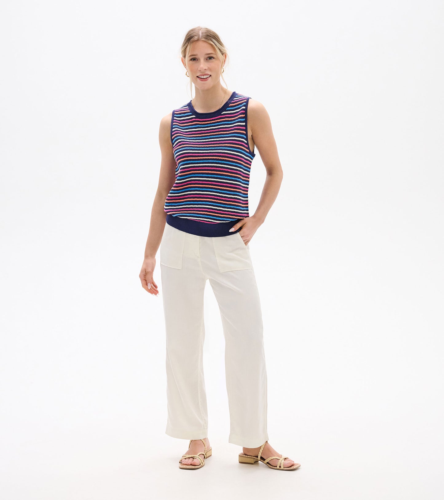 Sleeveless knit tank top with navy, pink, blue, and white horizontal stripes, front view on model