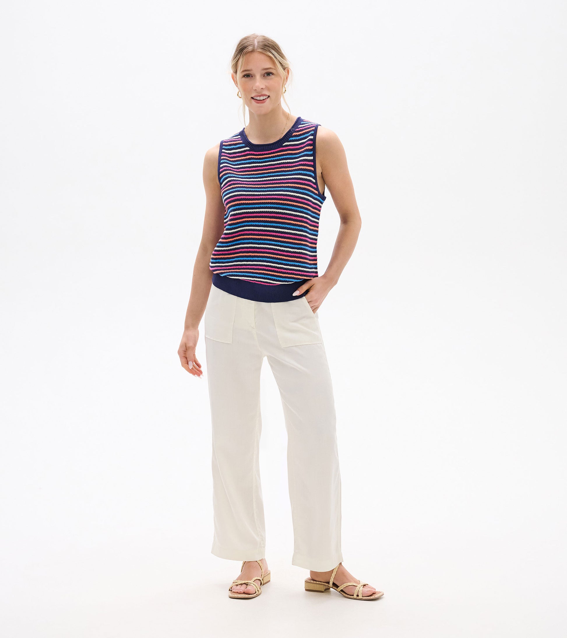 Sleeveless knit tank top with navy, pink, blue, and white horizontal stripes, front view on model