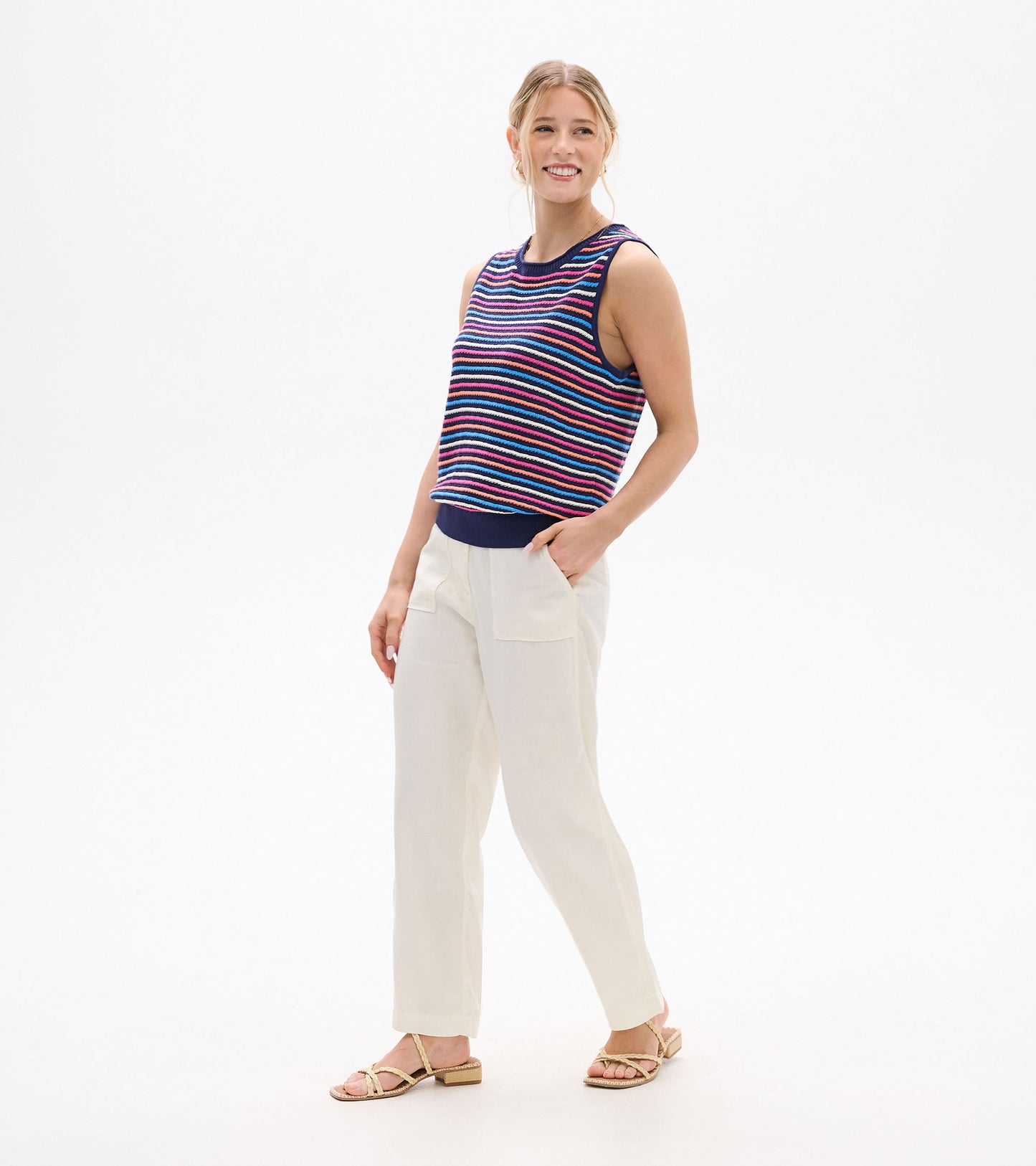 Sleeveless striped knit tank top in navy, pink, blue, and white, shown on a model.