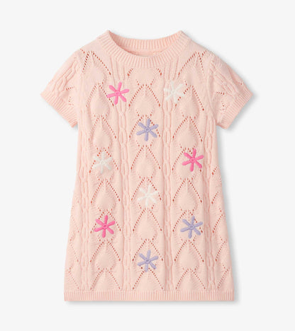 Light pink short-sleeve crochet dress with floral cutout pattern and multicolor flower appliqués, front view