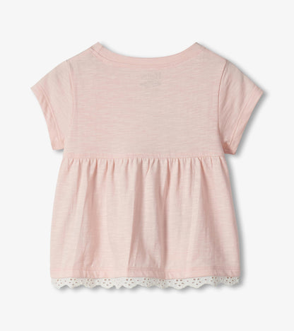 Light pink short-sleeve toddler top with gathered waist and lace hem, back view