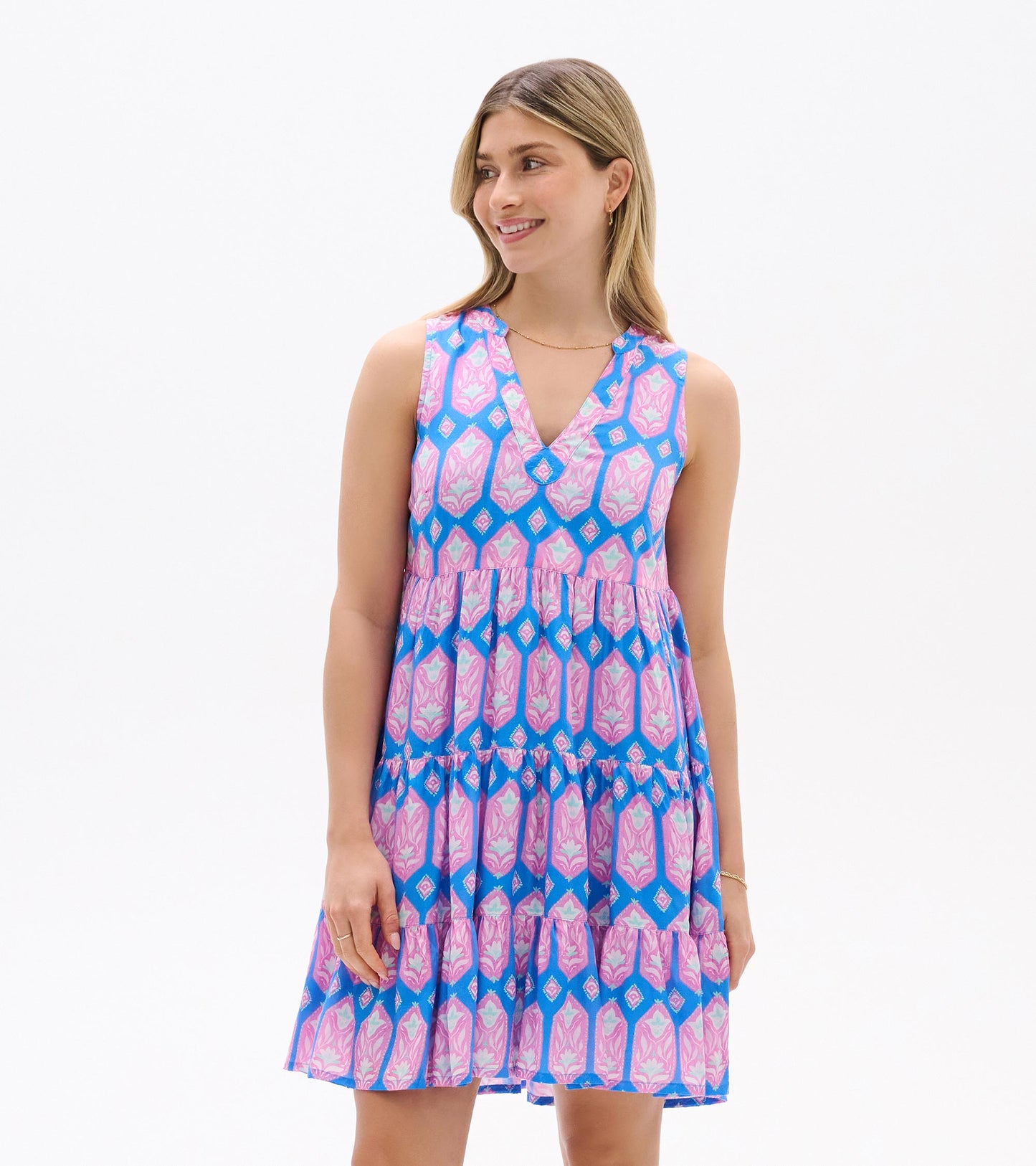 Sleeveless V-neck dress with pink and blue floral geometric print, tiered skirt, front view
