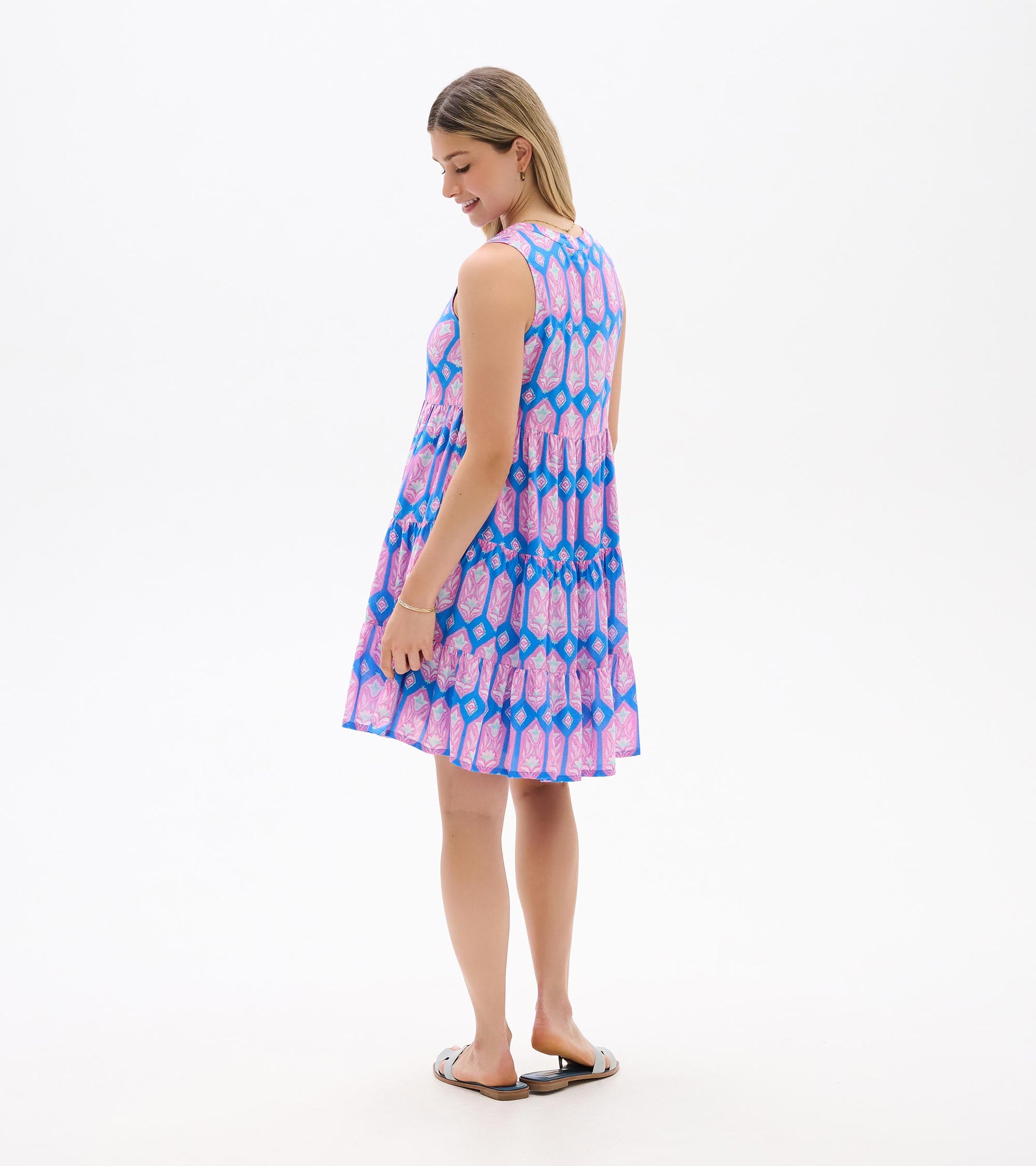 Sleeveless pink and blue patterned tiered dress, back view, knee length with a flared skirt