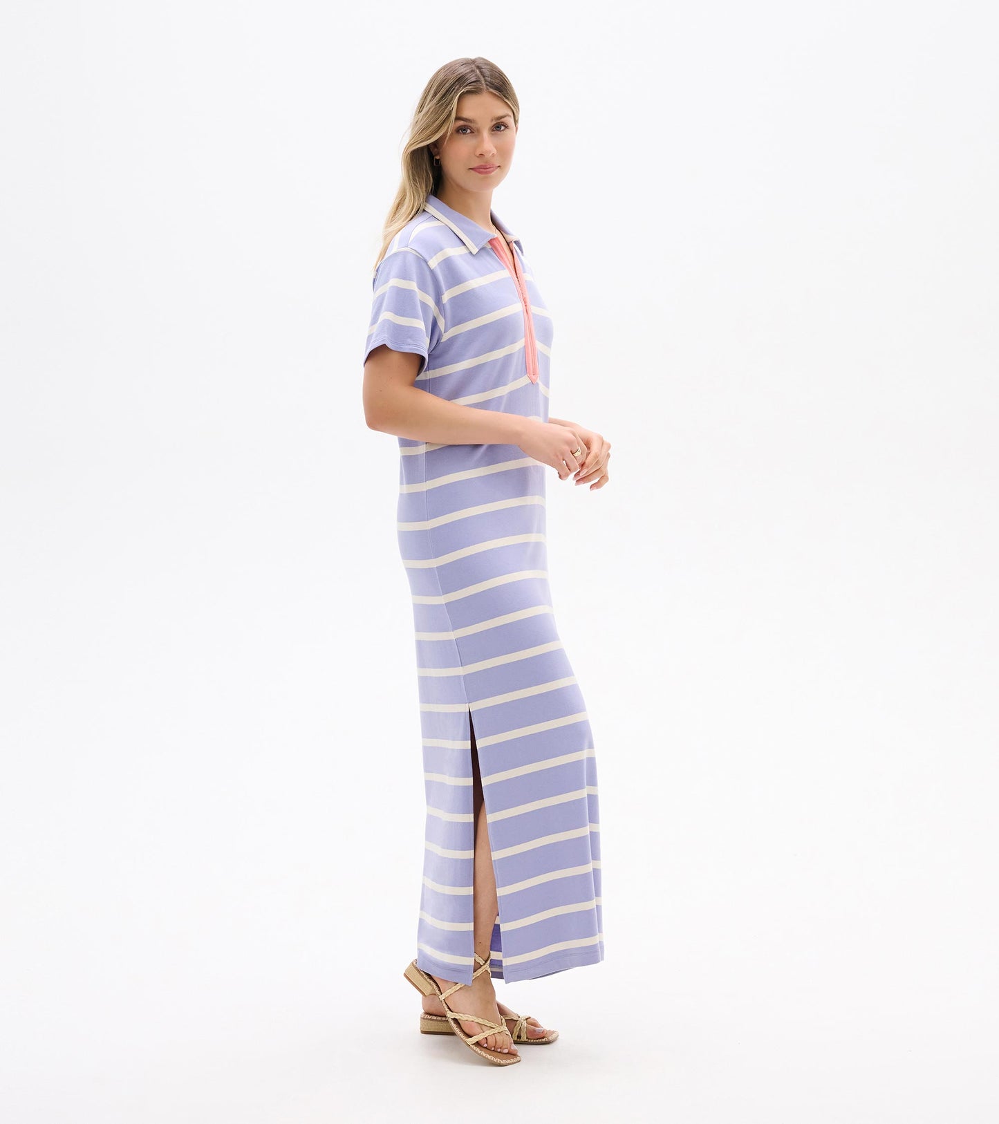 Pale lavender striped maxi dress with short sleeves, collar, zip neckline, and side slit, shown on model in side view