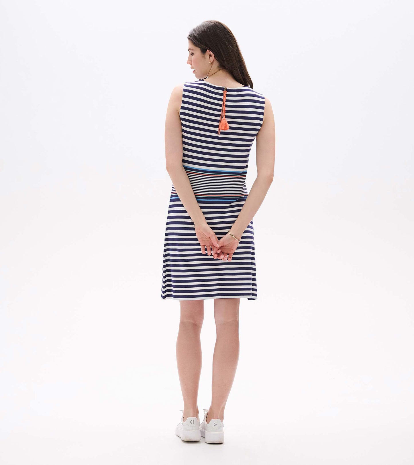 Sleeveless navy and white striped dress with coral tassel tie, back view, knee length
