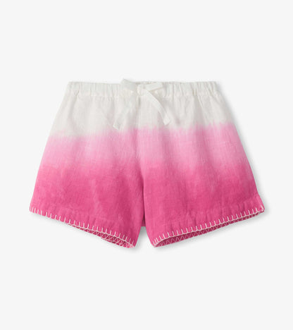 Girls woven shorts with white-to-pink dip dye, elastic waist, and stitched hem, front view
