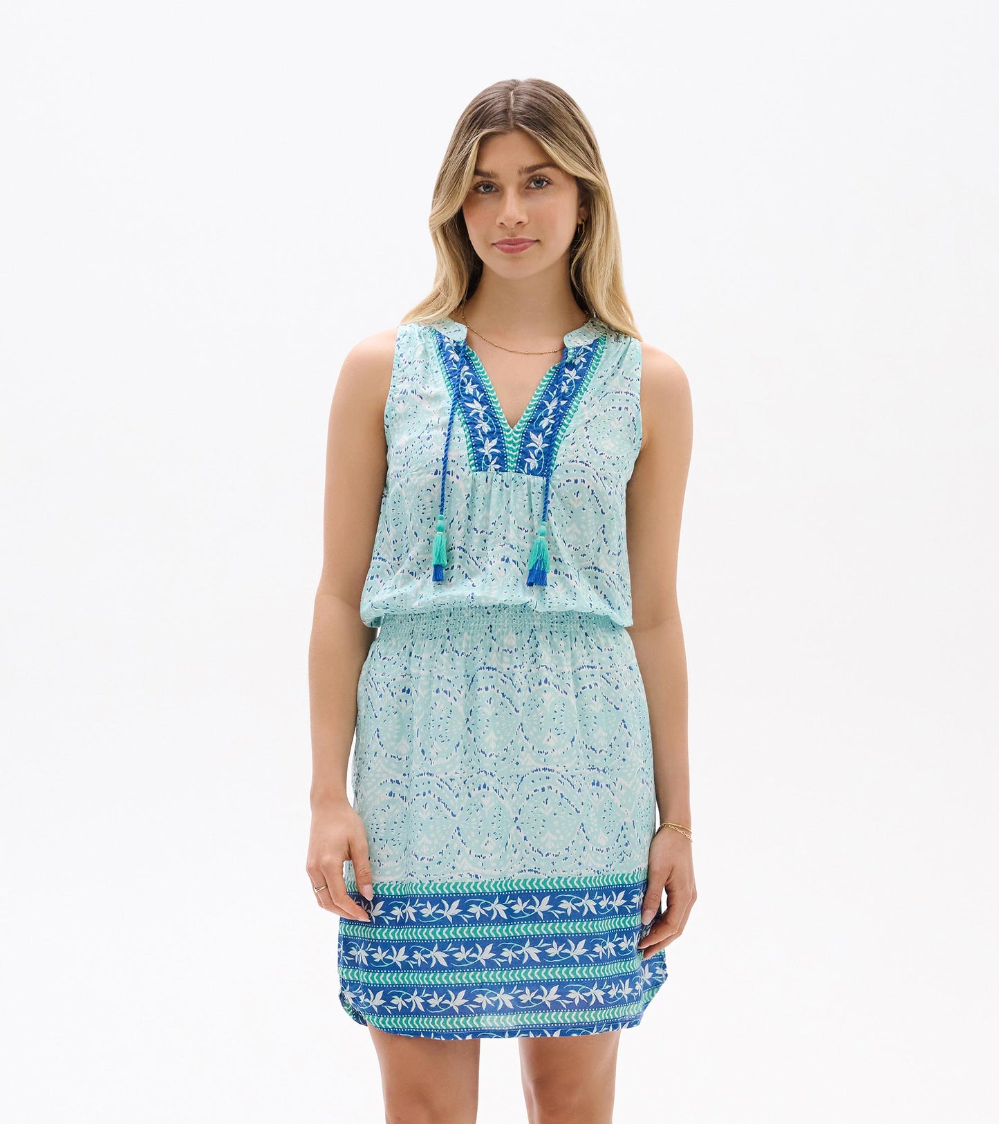 Sleeveless light blue ikat dress with V-neck, tassel ties, and patterned hem, front view