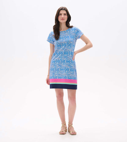 Front view of blue and white ikat tee dress with short sleeves and pink, aqua, and navy striped hem