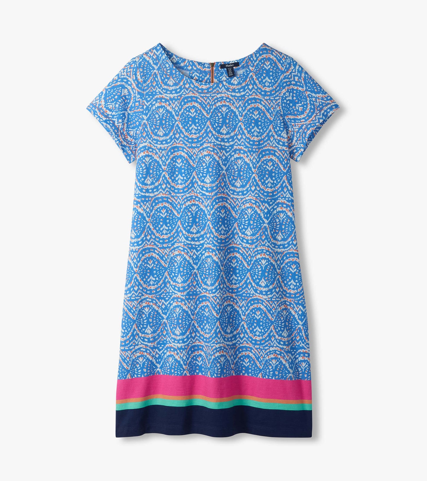 Flat lay of blue and white ikat tee dress with short sleeves and pink, aqua, and navy border hem