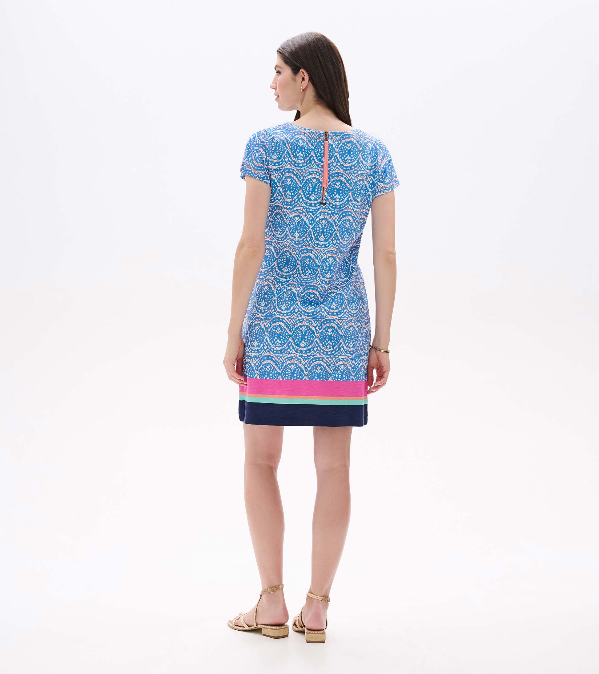Back view of blue and white ikat tee dress with short sleeves, striped hem, and visible back zipper