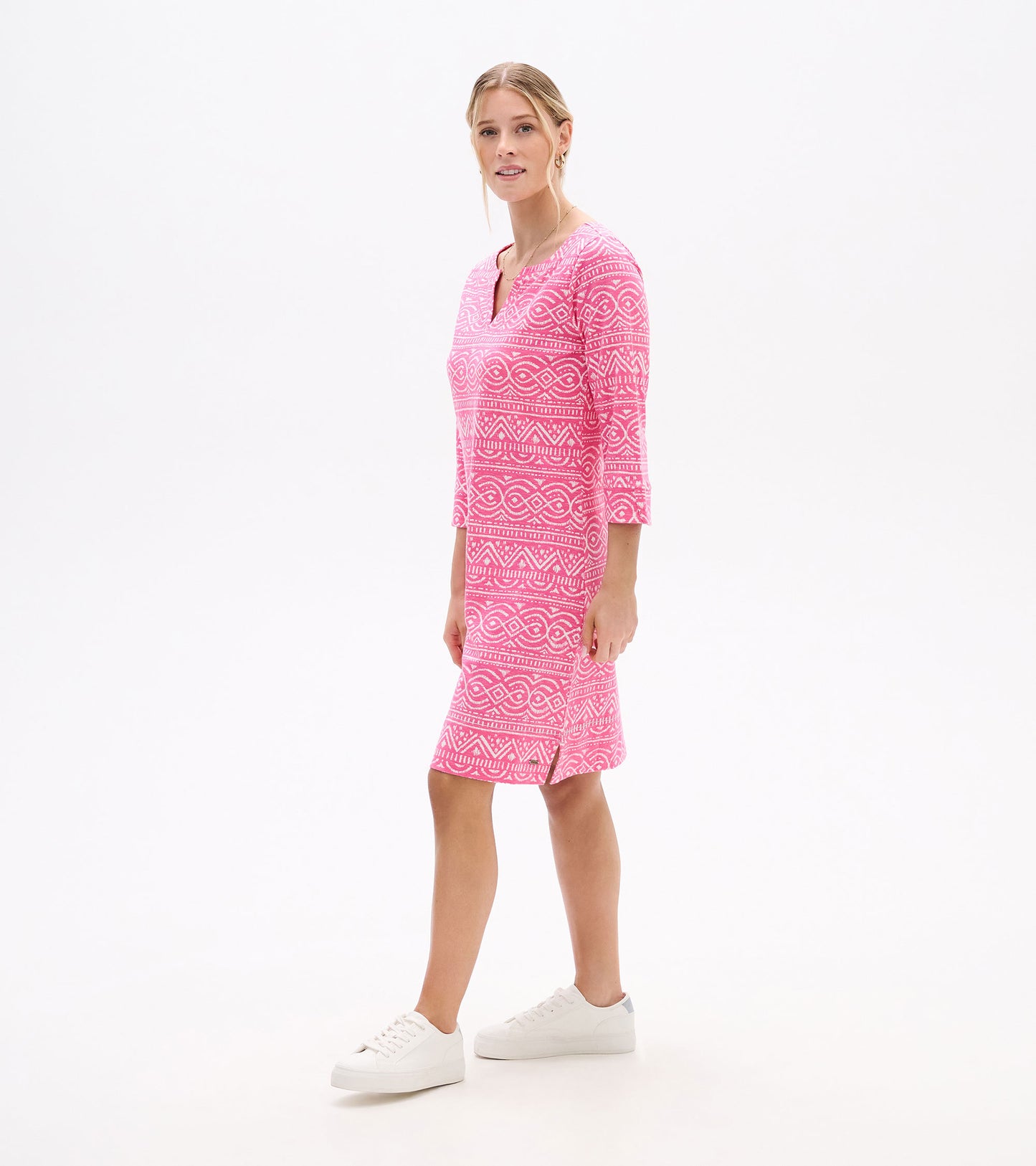 Pink patterned notch-neck dress with three-quarter sleeves, shown on a model, front view