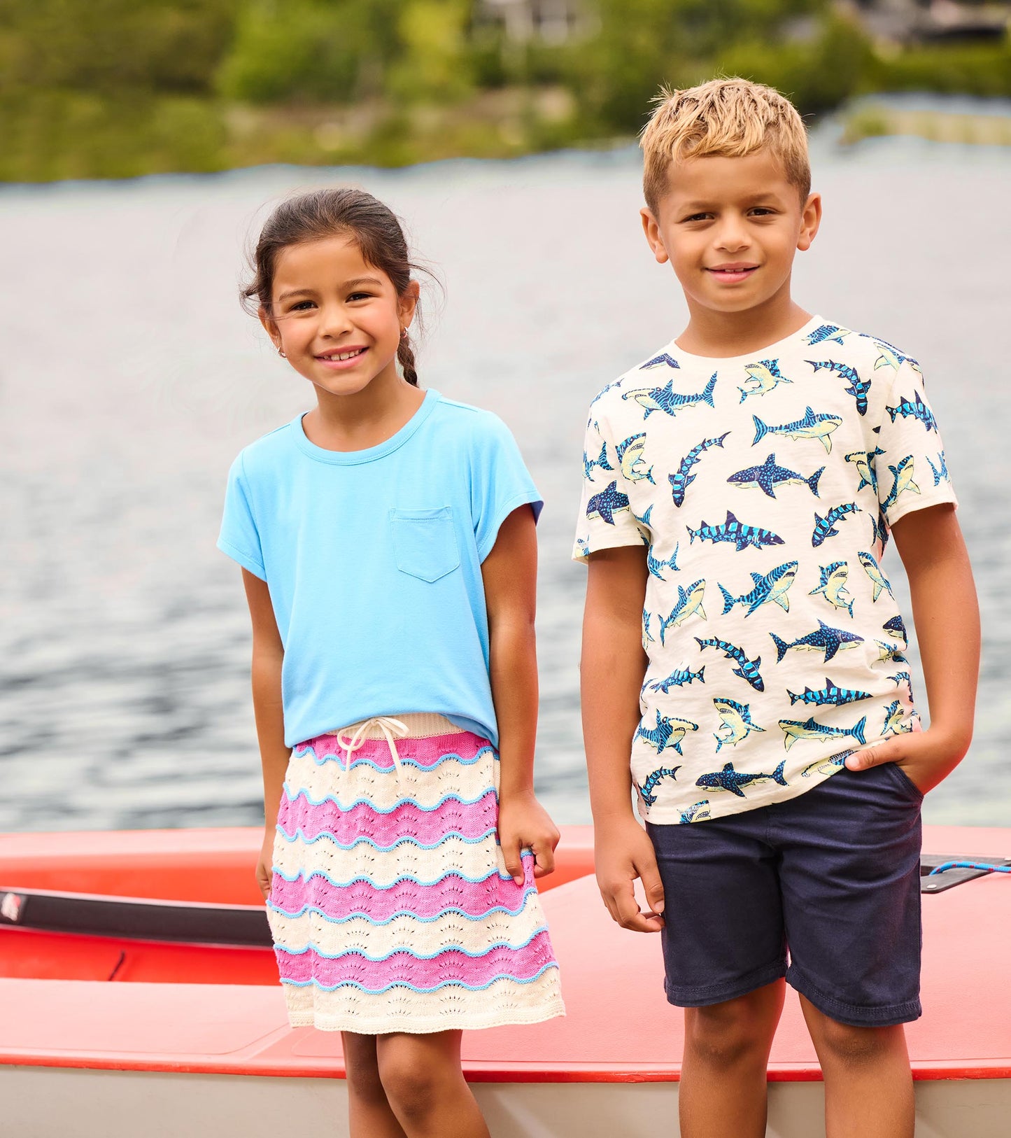 Girls pink, cream, and blue striped crochet skirt with scalloped hem, worn by a child outdoors