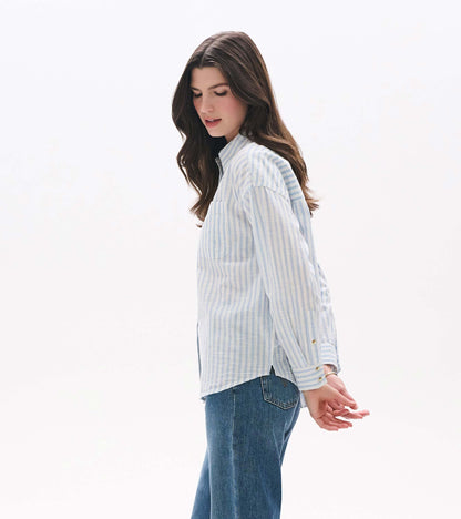 Side view of relaxed blue and white striped button-down shirt with chest pocket and curved hem