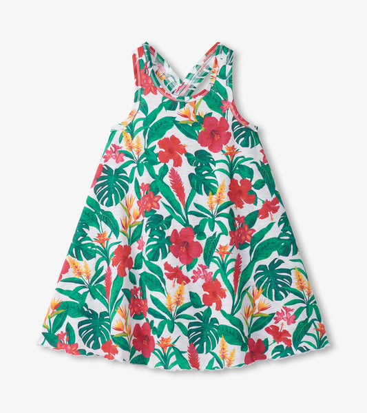 Girls white trapeze dress with green, red, and yellow tropical floral print and scoop neckline