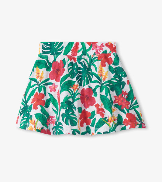 Girls tropical floral floaty skort with white background, green leaves, and red pink flowers