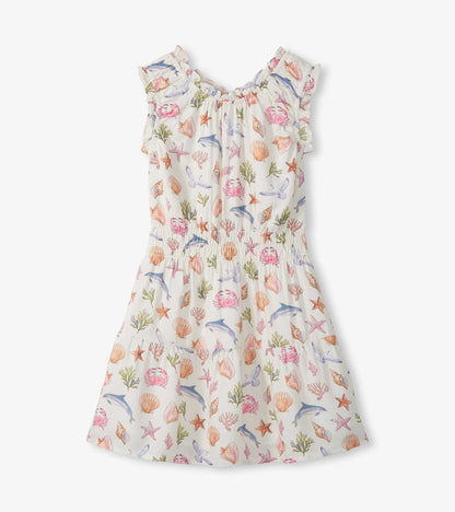 Girls cream gathered dress with colorful sea life print and ruffled sleeves, front view