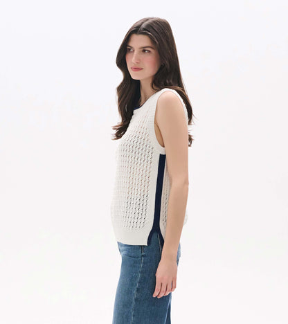 White sleeveless knit tank top with openwork texture, shown on model in side view with blue side trim