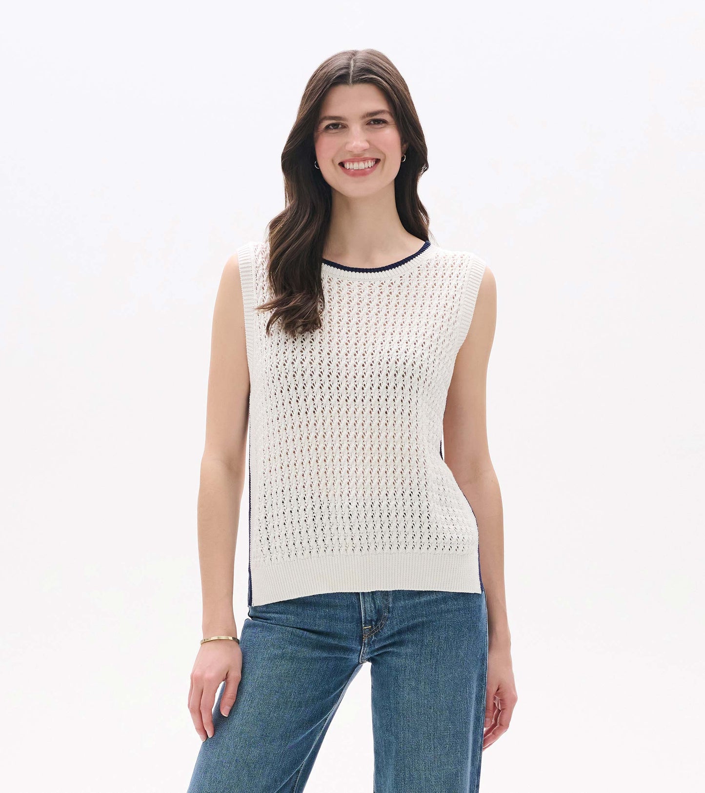 White sleeveless knit tank with openwork texture, ribbed trim, and navy contrast neckline, front view on model.