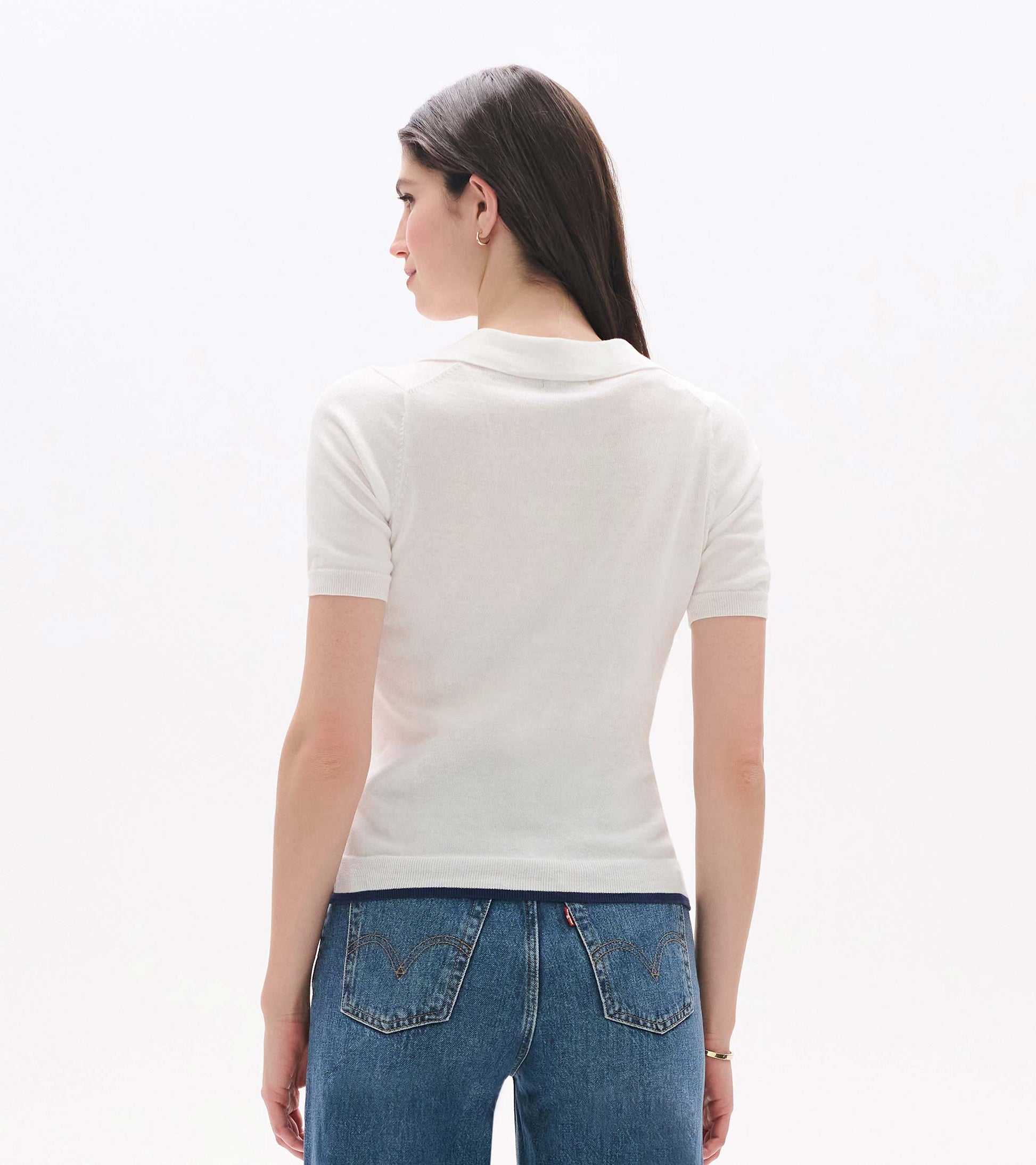 Back view of a white short-sleeve knit polo top with a Johnny collar and fitted waist.