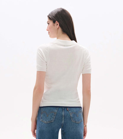 Back view of a white short-sleeve knit polo top with a Johnny collar and fitted waist.