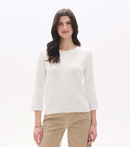 White knit top with 3/4 sleeves and a round neckline, shown on a model front view.