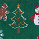Embroidered Christmas tree with ornaments and star, candy canes, snowflakes, and part of a snowman on green fabric