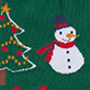 Snowman with red scarf and purple hat beside a decorated Christmas tree