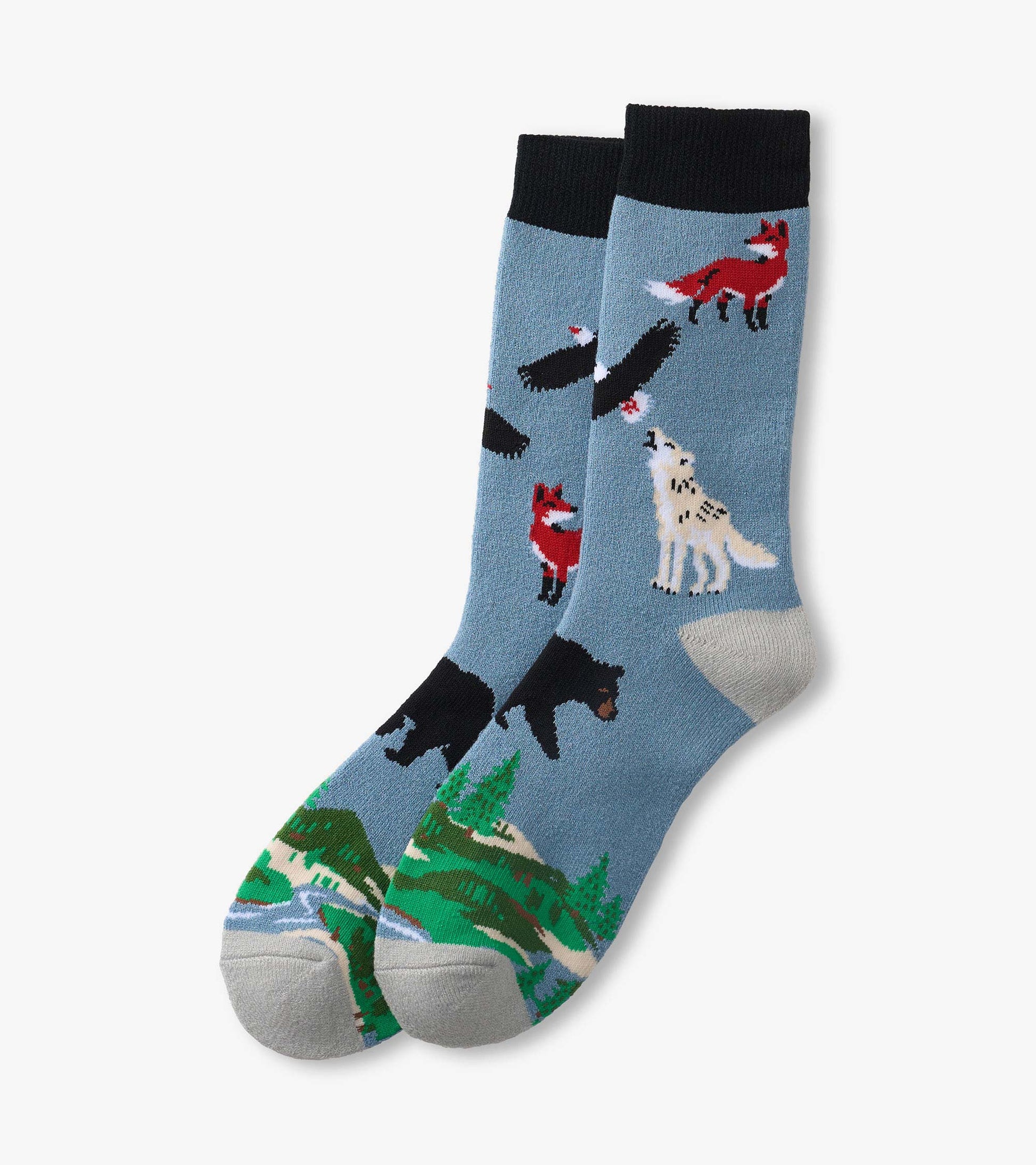 Blue crew socks with black cuffs, featuring fox, bear, wolf, eagle, and forest landscape pattern