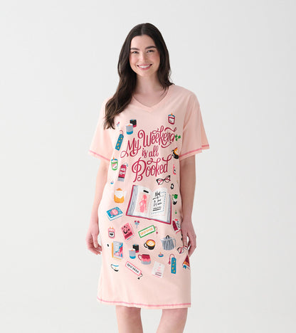 Front view of pink V-neck sleepshirt with 'My Weekend is All Booked' text and book-themed icons