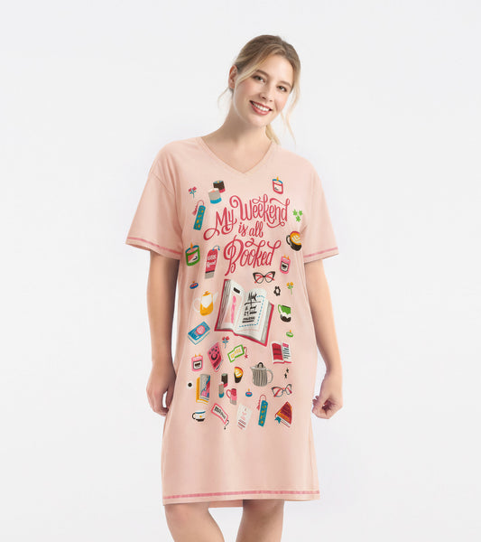 Pink women's sleepshirt featuring a playful book-themed graphic and a V-neck design, suitable for lounging.