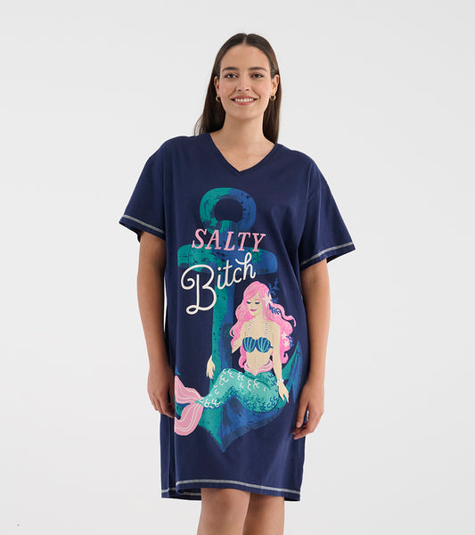 Woman wearing a navy V-neck sleepshirt with short sleeves and a Salty Bitch mermaid and anchor graphic