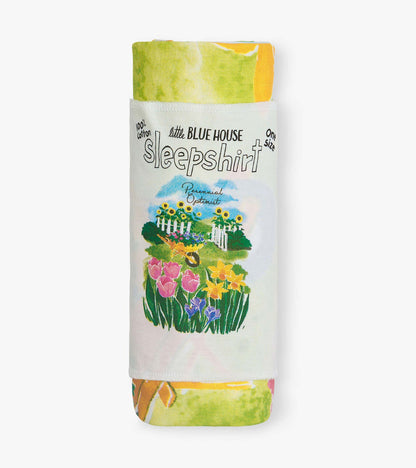 Folded white cotton sleepshirt with colorful floral garden print and “Perennial Optimist” text