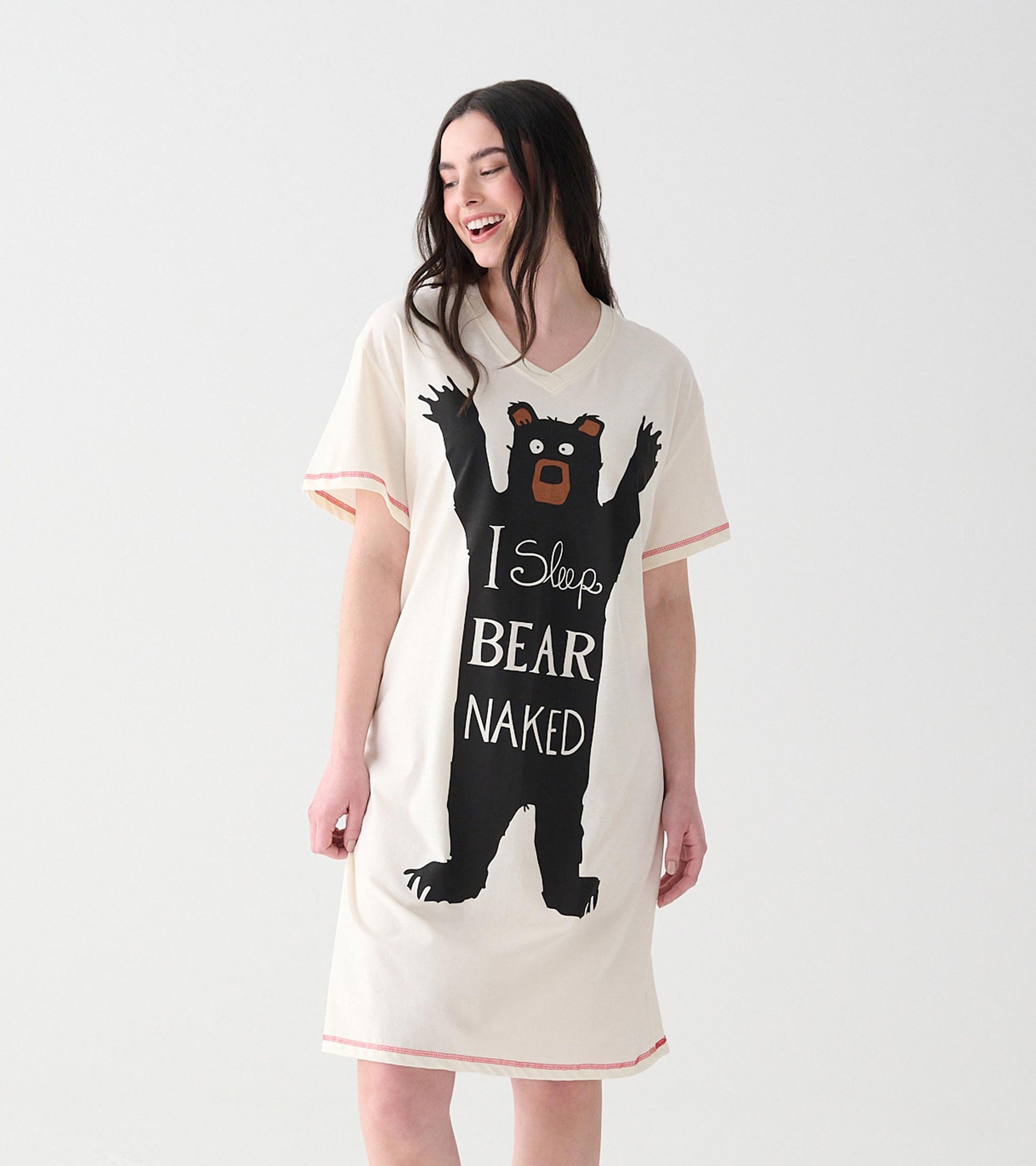 Women's cream sleepshirt with short sleeves, pink trim, and large black bear graphic with slogan on front