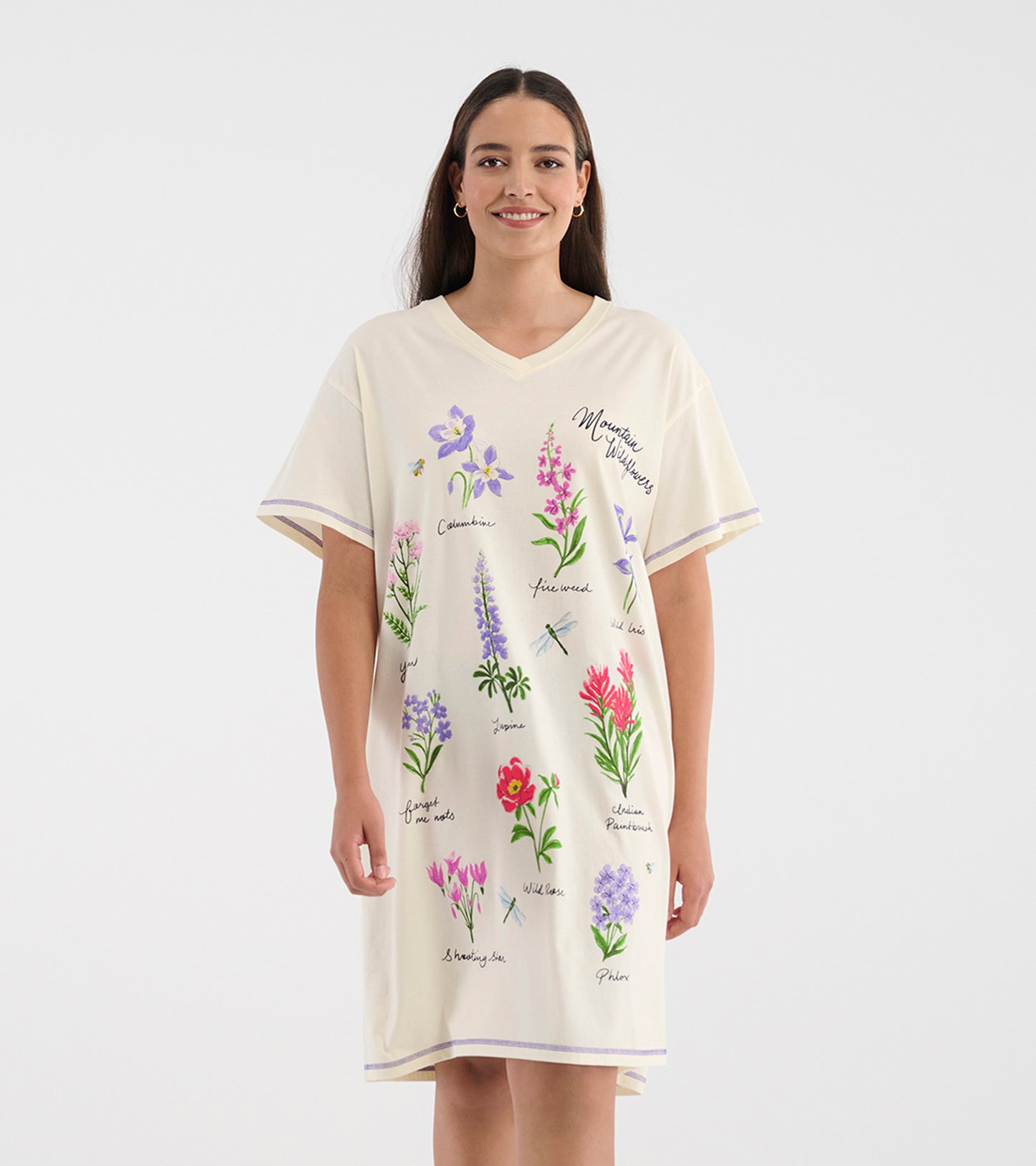 Model wearing cream V-neck sleepshirt with short sleeves and colorful wildflower illustrations