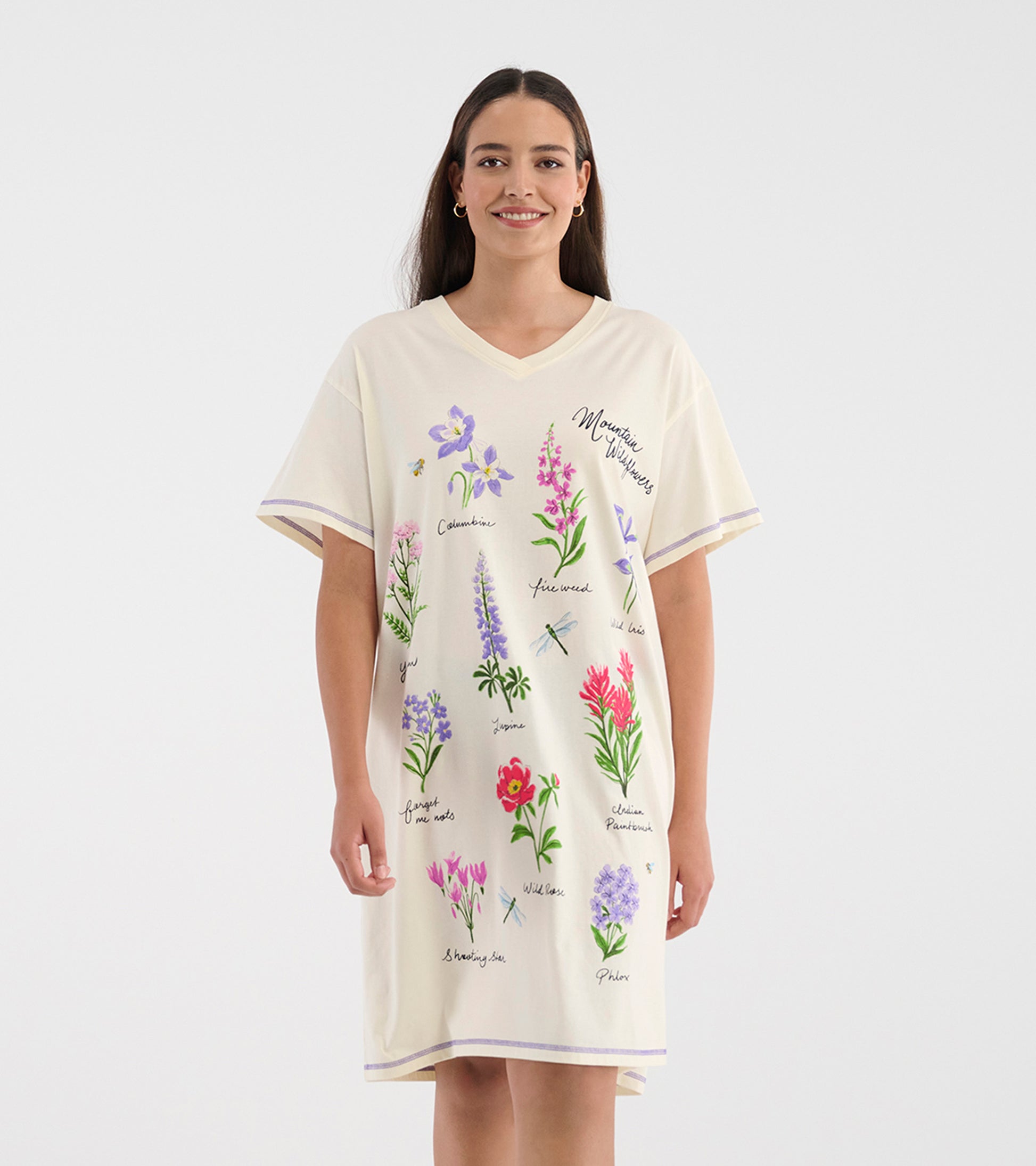 Model wearing cream V-neck sleepshirt with short sleeves and colorful wildflower illustrations