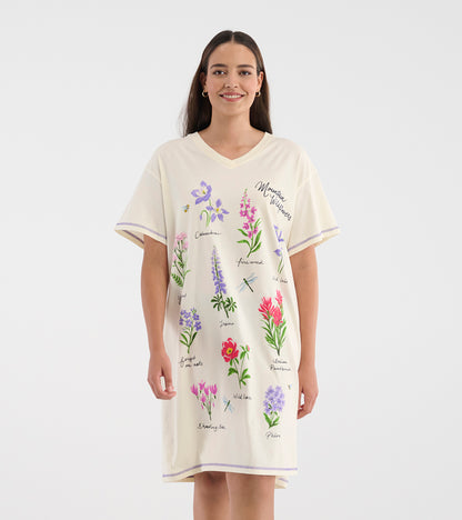 Model wearing cream V-neck sleepshirt with short sleeves and colorful wildflower illustrations