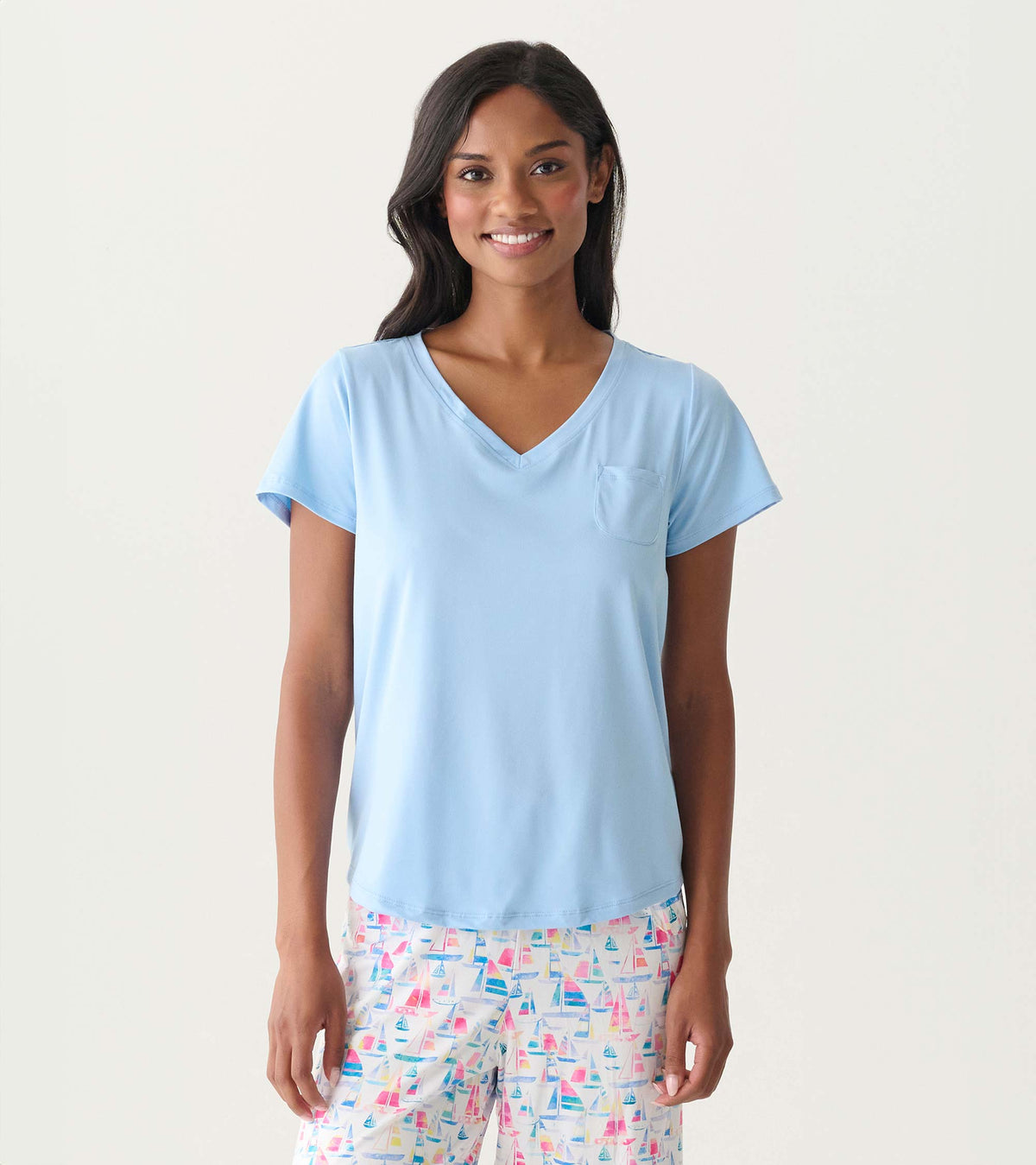 Women's placid blue V-neck T-shirt with short sleeves and a chest pocket, shown on model
