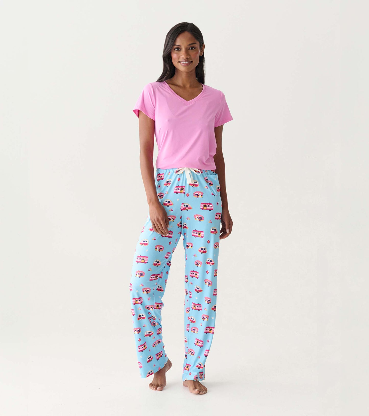 Woman wearing a pink V-neck T-shirt with blue printed pajama pants, front view