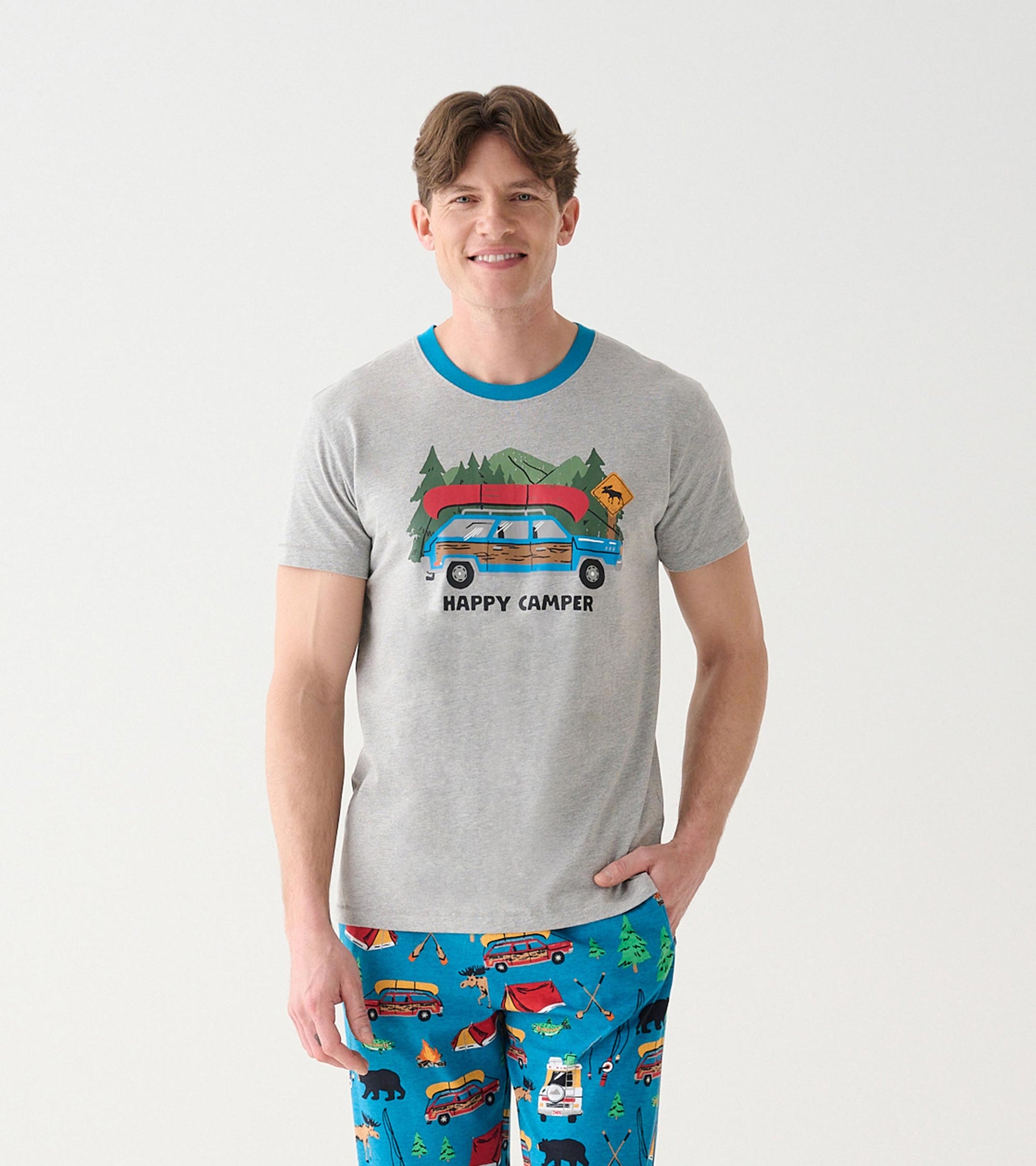 Model wearing heather gray camping T-shirt with blue crew neck and wagon, canoe, and Happy Camper graphic