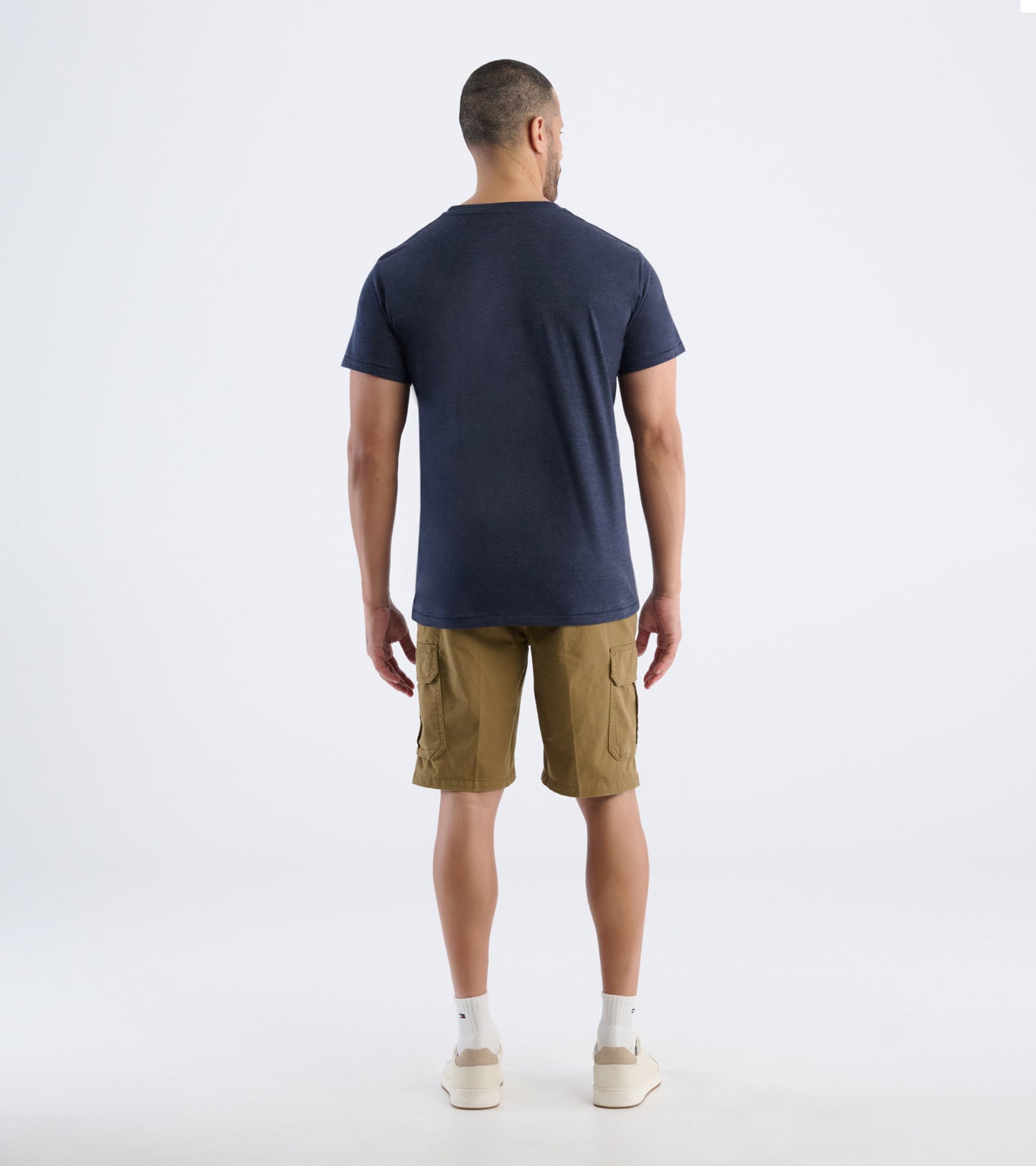 Back view of navy men's short sleeve tee on model
