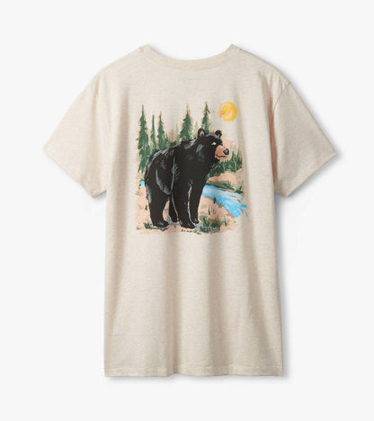 Men's Wilderness Bear T-shirt laid flat, showing back graphic of black bear, trees, blue stream and sun