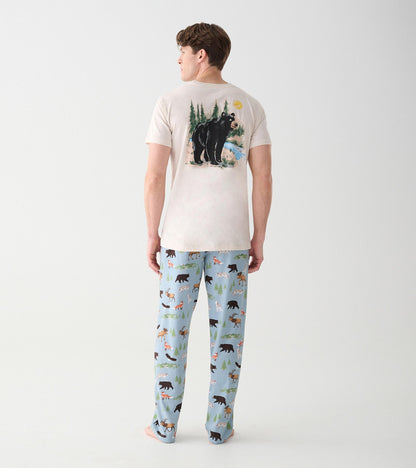Full back view of oatmeal short sleeve T-shirt with wilderness bear scene graphic on model