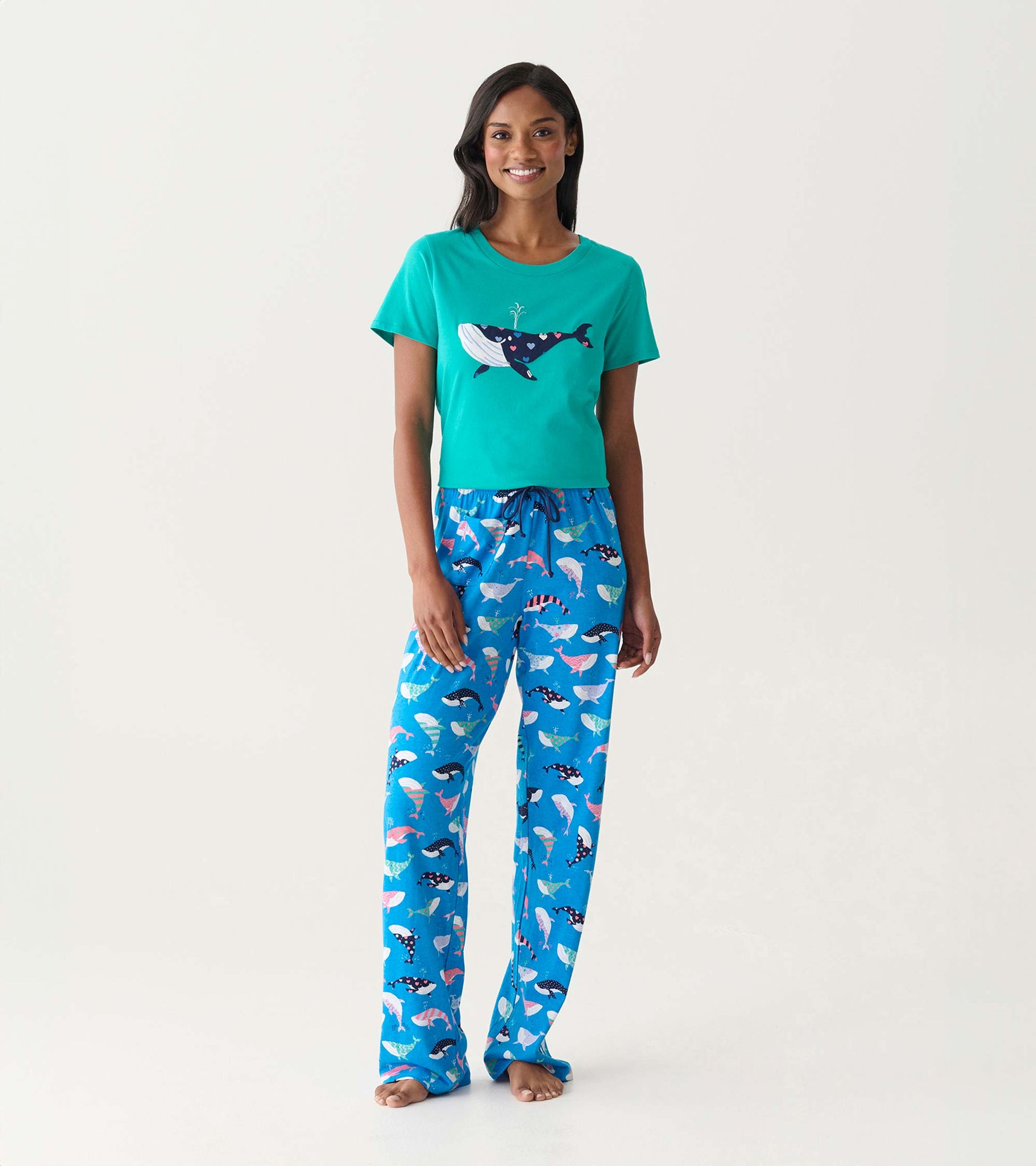 Teal short-sleeve pajama T-shirt with whale graphic and blue whale-print pajama pants, front view