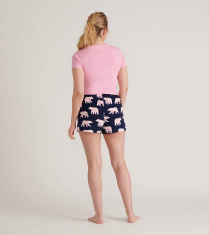 Back view of a pink short-sleeve pajama T-shirt with navy bear-print shorts on a model