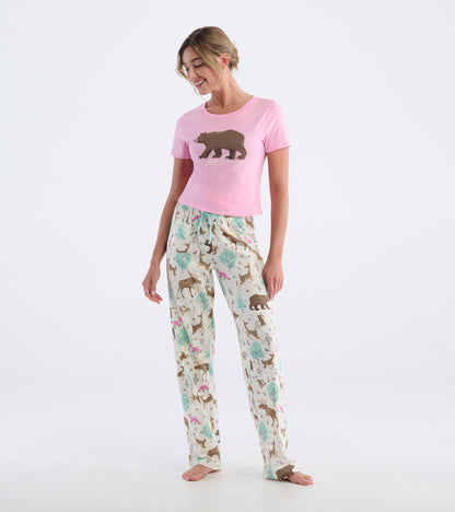 Pink short-sleeve pajama T-shirt with bear graphic, shown with matching animal-print pajama pants on a model.