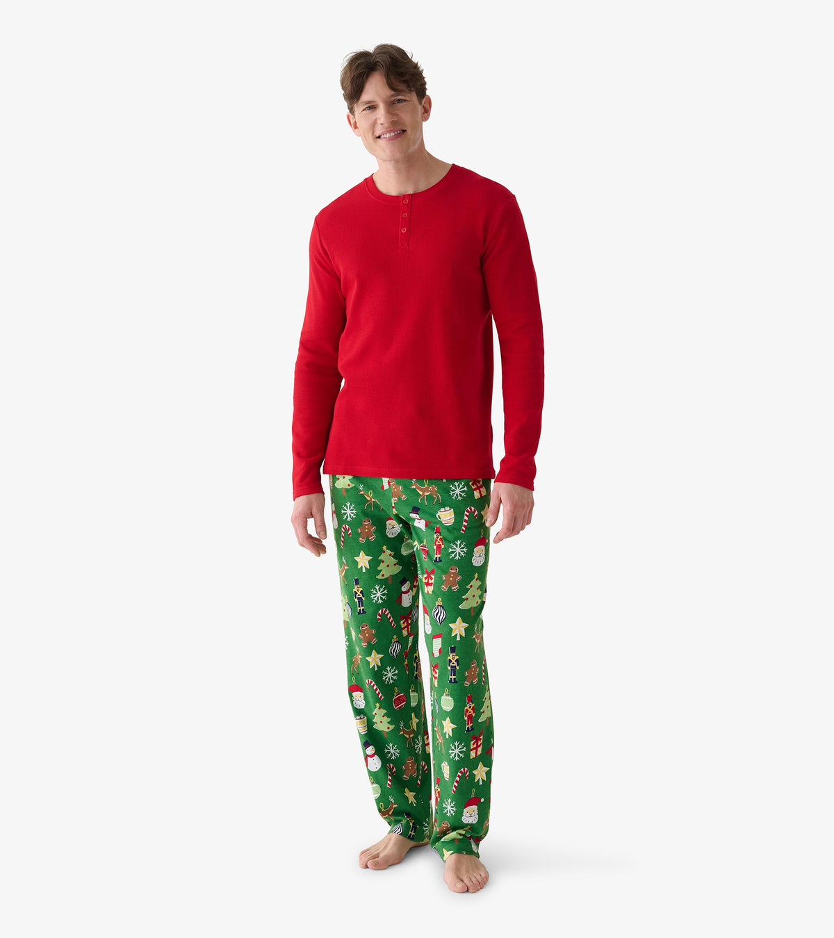 Men's red waffle henley shown full length from the front with green holiday print pajama pants