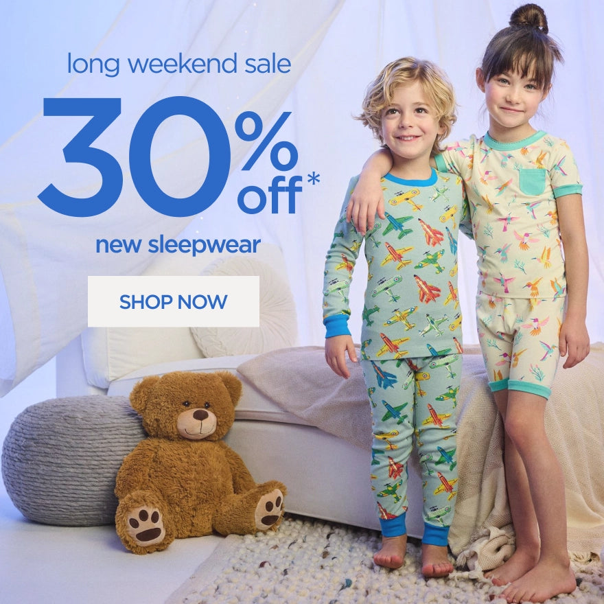 Promotes a long weekend sale on new sleepwear. Showing two kids stand in a bedroom wearing colorful printed pajamas.
