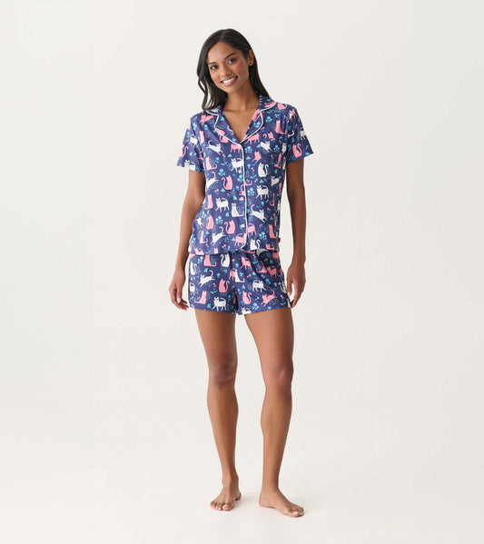 Short-sleeve button-down pajama set with navy cat print and matching shorts, modeled front view